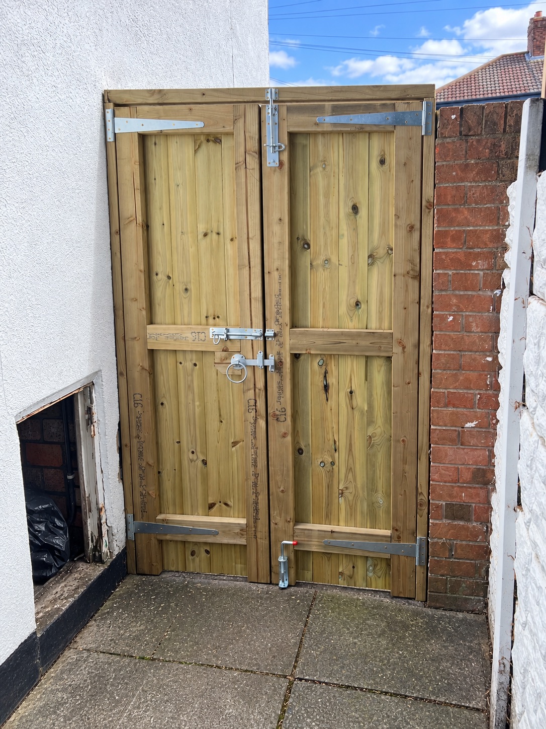 Pair of heavy timber gates fitted across a wide yard opening
