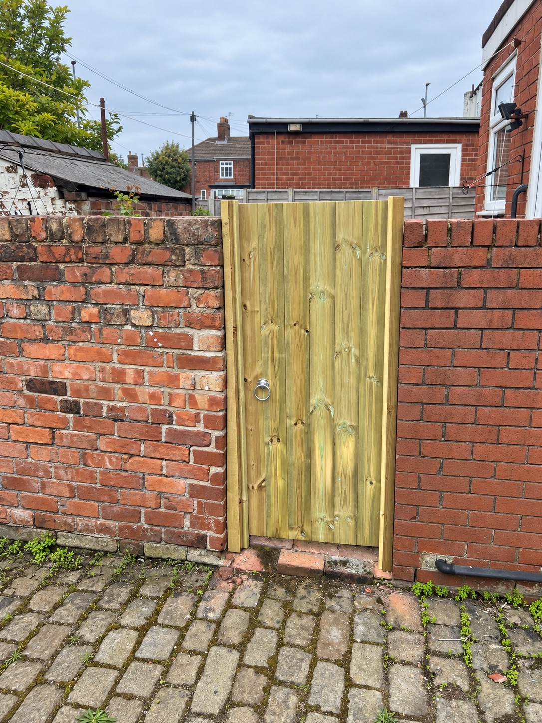 Natural timber gate fitted into a traditional Liverpool back yard wall
