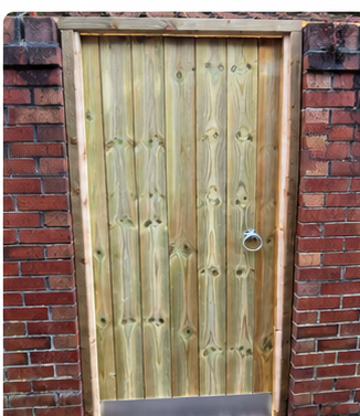 Close-boarded timber gate fitted in a brick opening